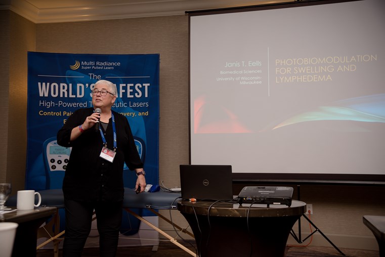 Dr. Janis T. Eells presenting photobiomodulation research at a 2019 symposium